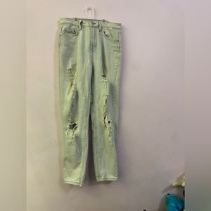 light-wash straight leg jeans, brown seams, rips from mid thigh to calf